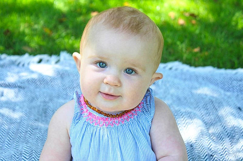 Chevelle is registered to the contest to win money with this photo: baby, cheek, child, close_up, eye, face, grass, head, iris, lip, person, photography, pink, plant, portrait, portrait_photography, skin, smile, summer, toddler