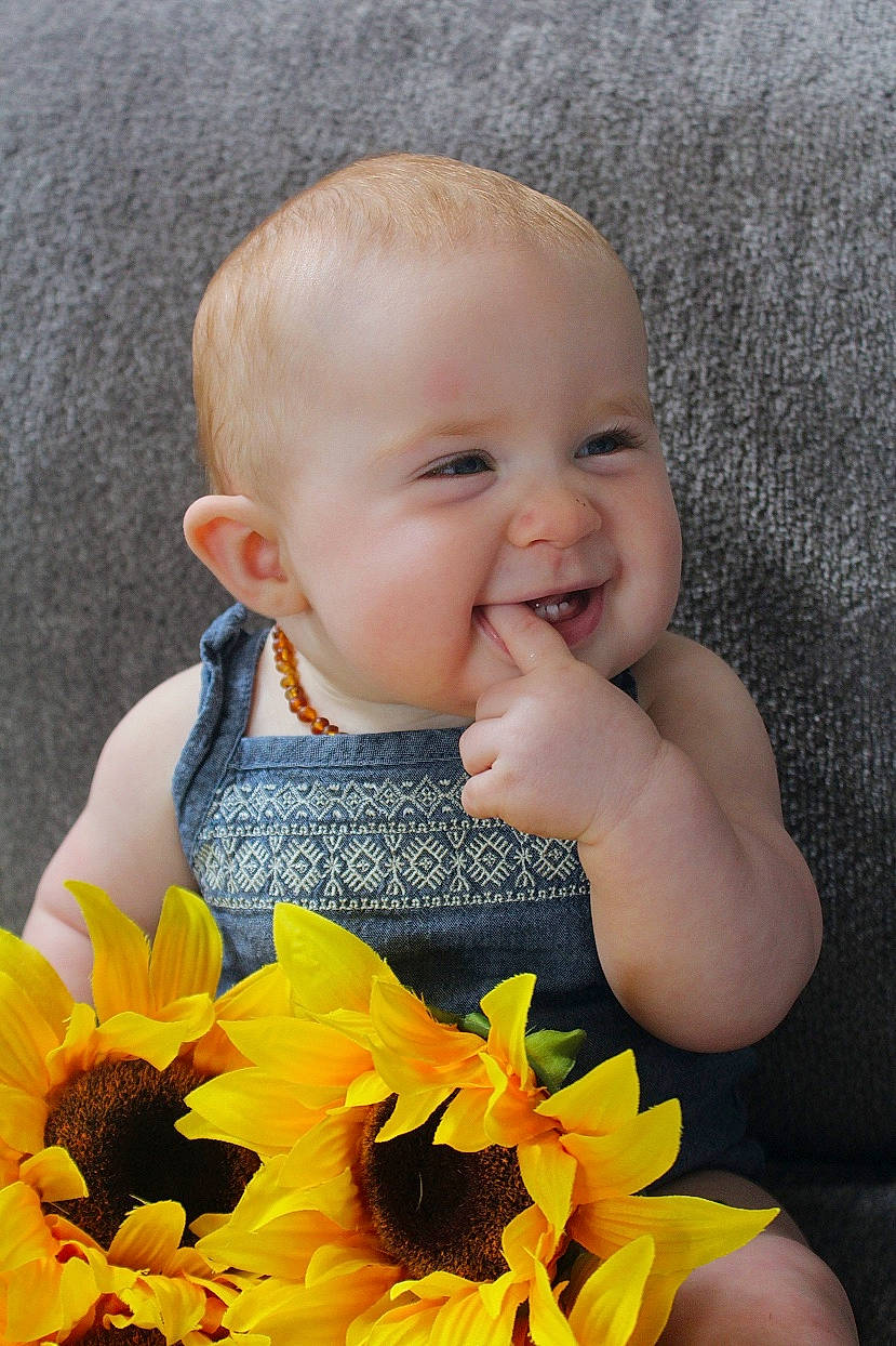 Chevelle is registered to the contest to win money with this photo: baby, cheek, child, eye, face, flower, happy, head, joy, mouth, nose, person, plant, skin, smile, sunflower, toddler, yellow
