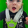 baby, child, swing, harness, green, black_shirt, open_mouth, outdoor, smiling, cute, infant, seatbelt, happy, strap, playground, closeup, face, person, young, seat