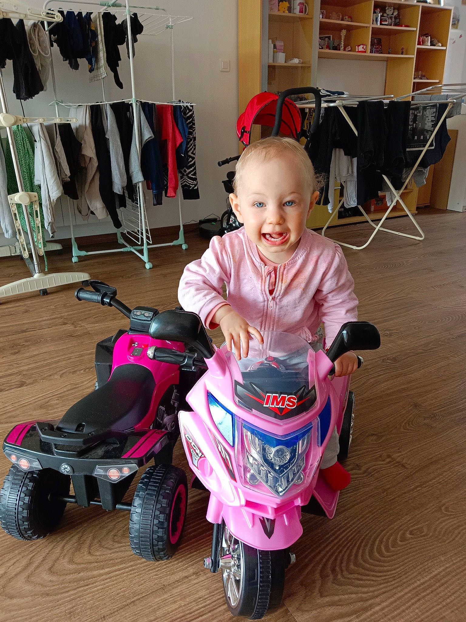 Layla participe au concours pour gagner de l'argent avec cette photo : automotive_design, automotive_tire, automotive_wheel_system, baby, baby_toddler_clothing, chair, child, floor, flooring, fun, magenta, motor_vehicle, person, product, riding_toy, smile, tire, toddler, toy, vehicle