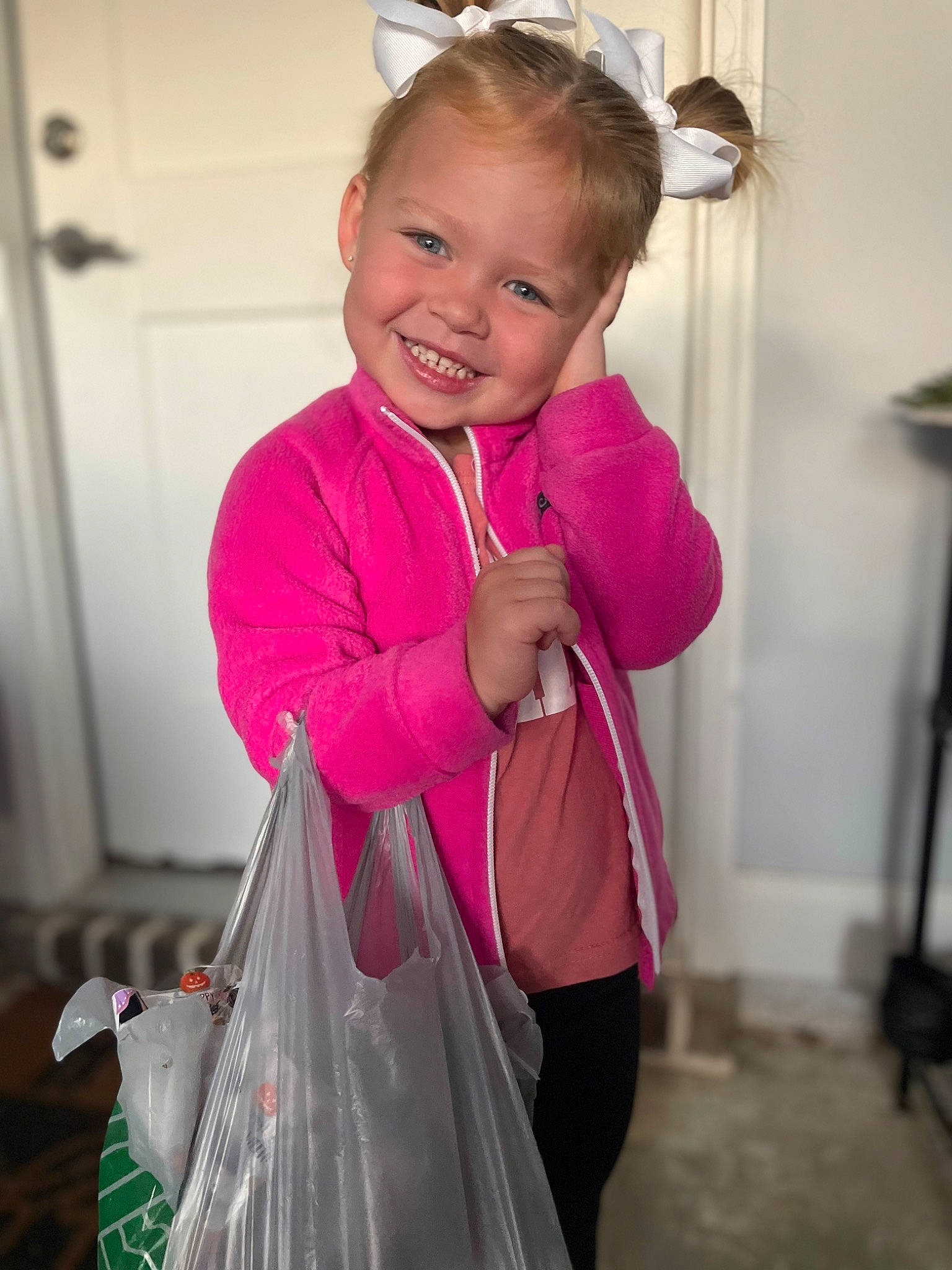 Katherine is registered to the contest to win money with this photo: baby_products, baby_toddler_clothing, child, cool, door, electric_blue, face, facial_expression, fashion_accessory, fun, hair, happy, joy, magenta, pattern, person, pink, plastic_bag, sleeve, smile