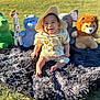 baby, child, crocodile, cute, elephant, giraffe, grass, happy, hat, hippo, lion, nature, outdoor, playtime, plush_toys, rug, sitting, smiling, stuffed_animals, sunlight