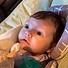 Anna joined the competition — help win amazing prizes! baby, infant, pacifier, plush_toy, giraffe, cushion, blanket, seat, child, portrait, indoors, soft_lighting, curious_expression, clothing, person, cute, young_child, closeup, face, comfort