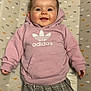 Noëlya participe au concours pour gagner de l'argent avec cette photo : baby, smiling, hoodie, adidas, plaid_pants, lying_down, changing_pad, patterned_background, happy, infant, clothing, cute, child, casual, indoor, person, young_child, face, fashion, cozy