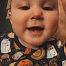 baby, child, smiling, face, onesie, milk_carton, cookies, indoor, portrait, happy, cute, person, clothing, head, infant, young_child, human, closeup, expression, blonde