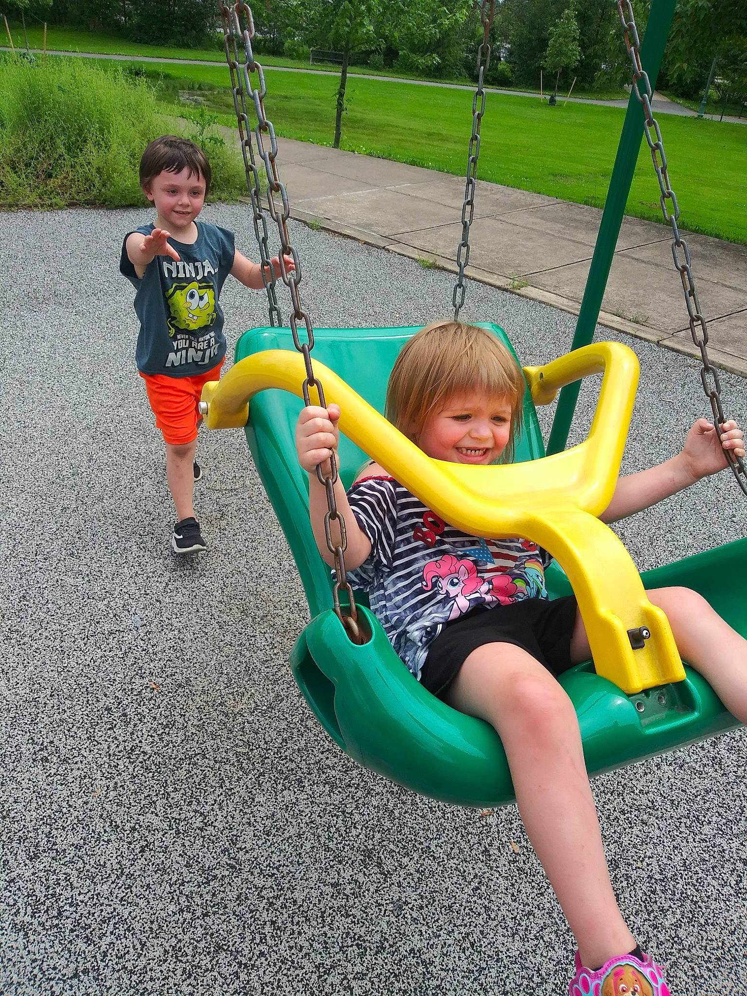 Trevor is registered to the contest to win money with this photo: child, city, fun, human_settlement, joy, leisure, outdoor_play_equipment, person, play, playground, public_space, recreation, swing