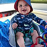 baby, baby_seat, barefoot, blue_hat, child, childhood, cute, happy, infant, outdoor, playful, seat_belt, shark_pattern, smiling, summer, sun_hat, sun_protection, swimsuit, towel, toy_strap