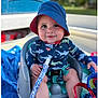Theo joined the competition — help win amazing prizes! baby, infant, child, bucket_hat, hat, swimwear, onesie, pacifier, pacifier_clip, seat, boat, towel, smiling, outdoors, portrait, sitting, safety_belt, happy, blue_color, vacation