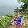 Malak joined the competition — help win amazing prizes! child, girl, fishing, camping_chair, rainbow_boots, water, lake, grass, greenery, nature, outdoor, smiling, happy, fishing_rod, reflection, casual_clothing, dirt_path, plants, daytime, recreation