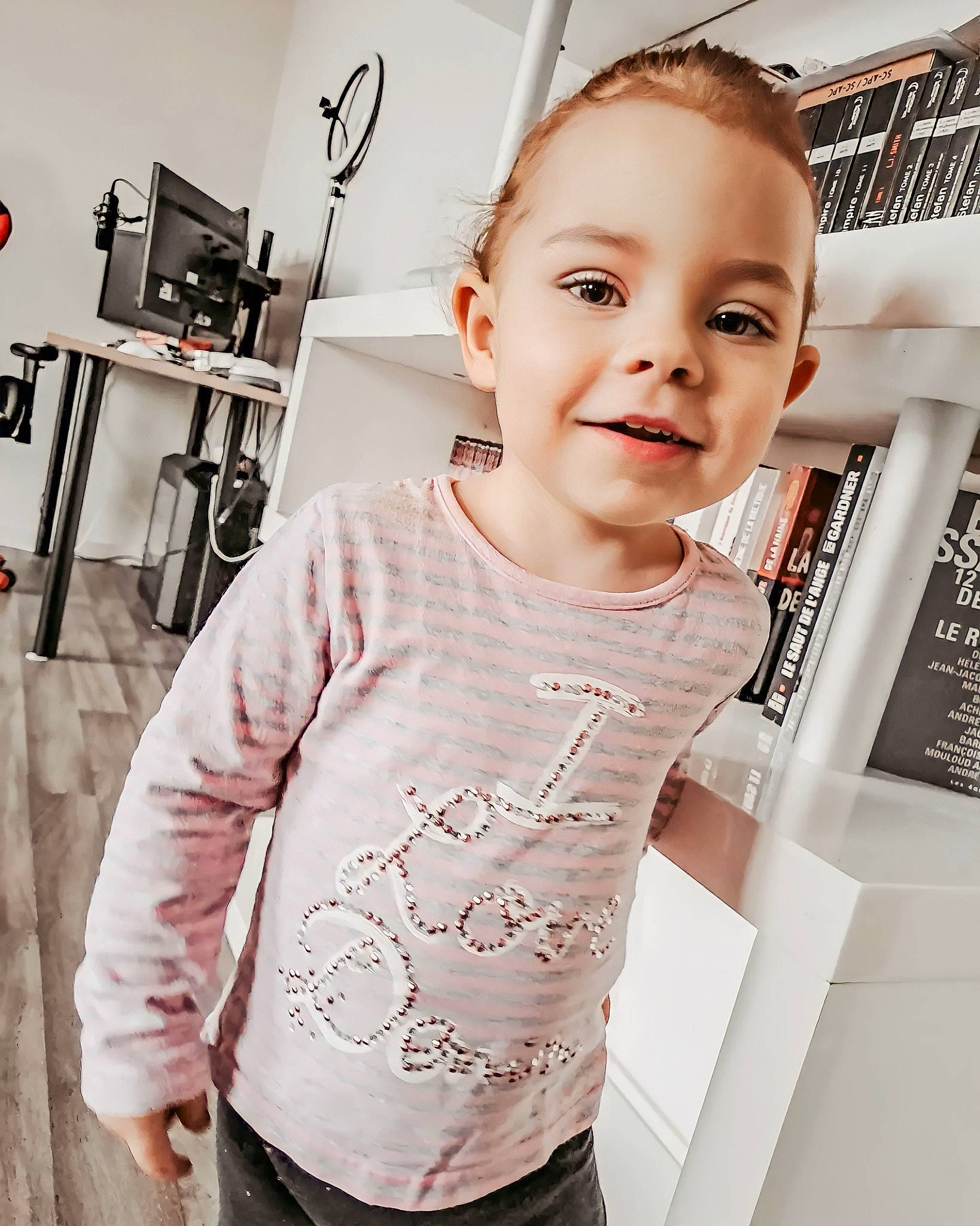 Alexia participe au concours pour gagner de l'argent avec cette photo : baby_toddler_clothing, child, cool, fashion_design, flooring, happy, joy, long_sleeved_t_shirt, magenta, neck, pattern, person, room, shoulder, skin, sleeve, smile, standing, style, t_shirt