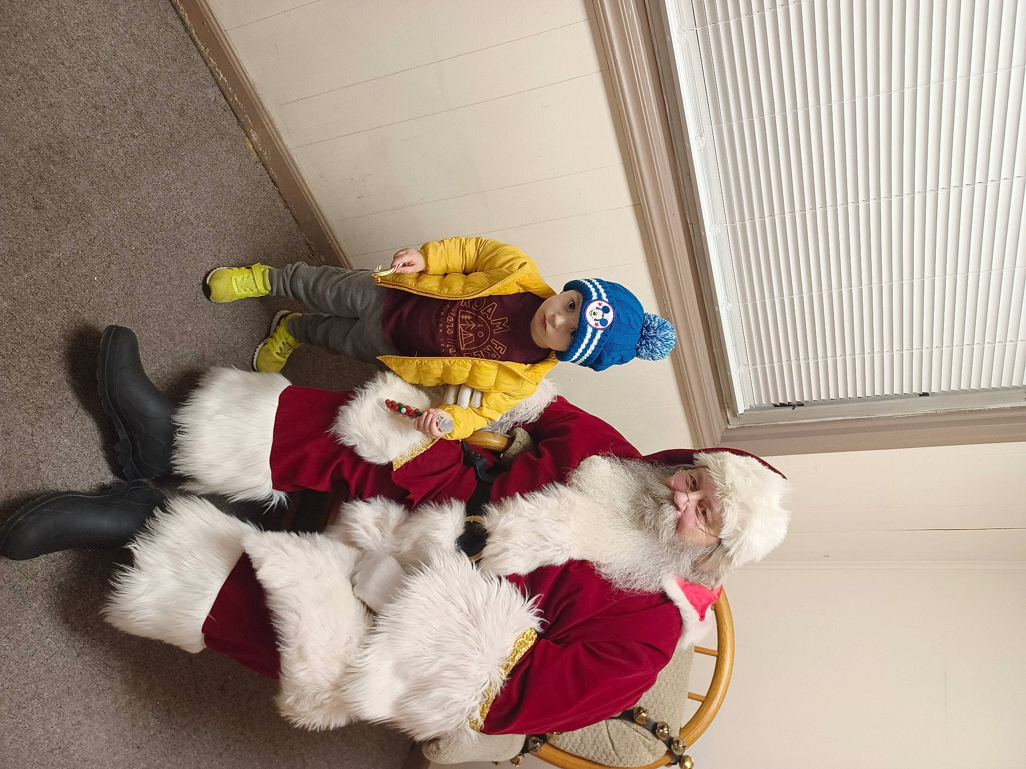 Caysen is registered to the contest to win money with this photo: carmine, comfort, costume, costume_hat, event, fictional_character, flooring, fun, fur, fur_clothing, glove, hat, headwear, lap, pattern, person, plush, room, santa_claus, sitting