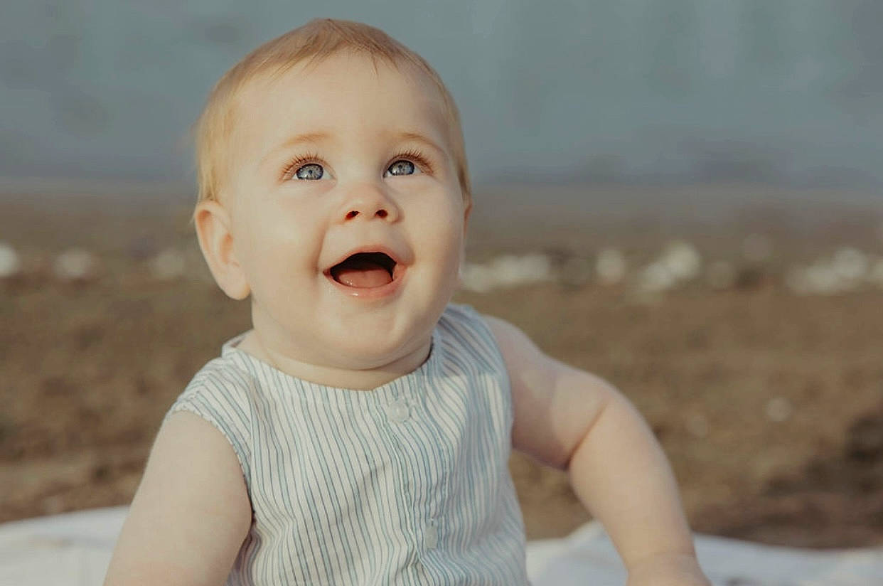 Cohen is registered to the contest to win money with this photo: baby, baby_laughing, baby_toddler_clothing, cheek, child, eye, face, flash_photography, fun, happy, iris, laugh, lip, nose, person, sand, sitting, skin, sleeve, smile