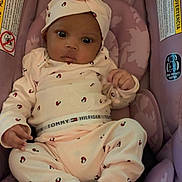 Hera joined the competition — help win amazing prizes! baby, infant, child, car_seat, purple, clothing, hat, onesie, socks, cute, indoors, seat, patterned_clothing, portrait, young_child, person, resting, comfortable, looking_at_camera, small_hands