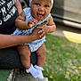 Paris joined the competition — help win amazing prizes! baby, child, smiling, headband, bow, blue_clothing, adult_hand, outdoor, grass, vehicle, happy, cute, infant, socks, holding, portrait, expressive_face, skin, person, daylight