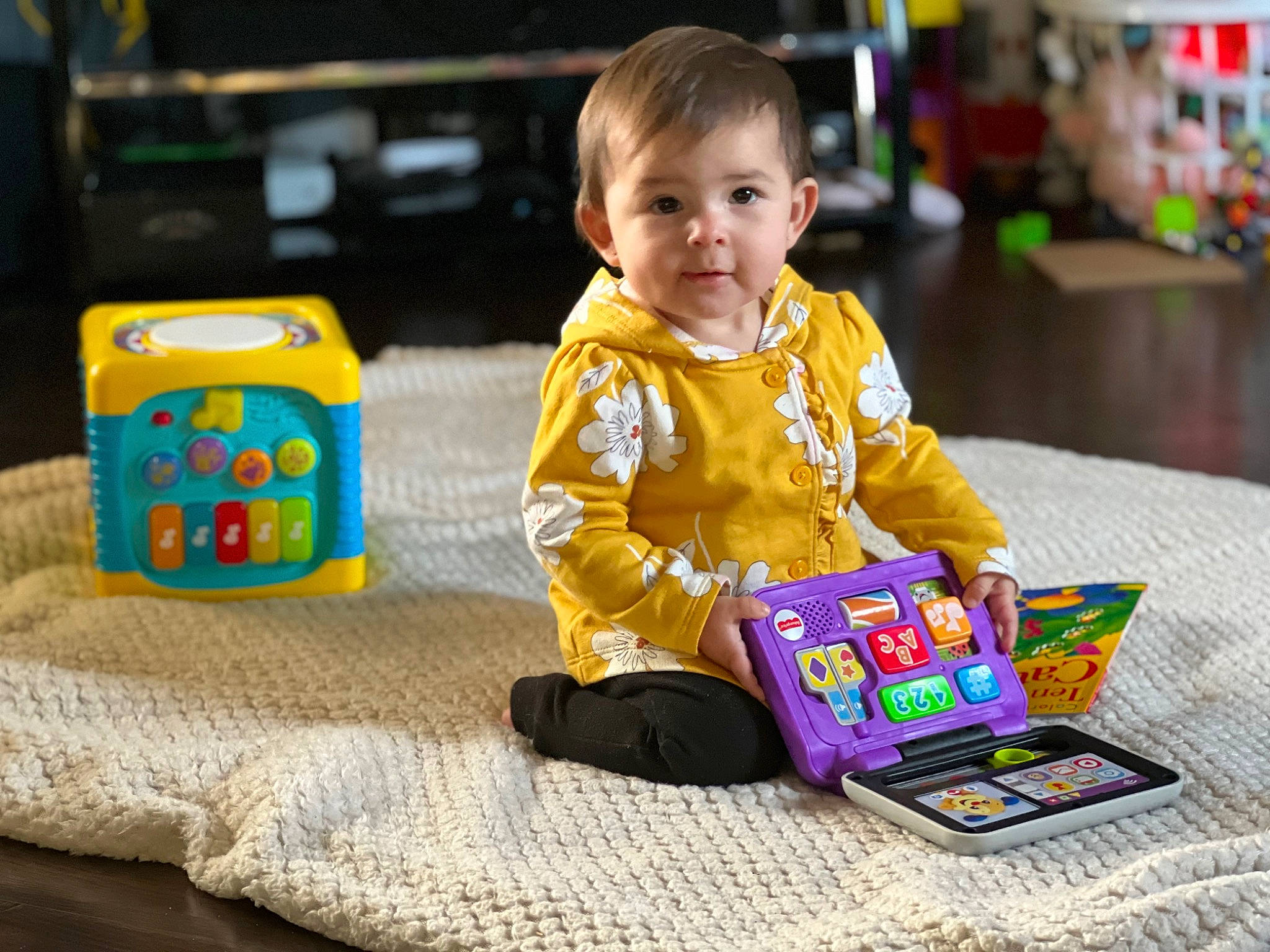 Elisabella is registered to the contest to win money with this photo: baby, baby_playing_with_toys, baby_toddler_clothing, child, clothing, communication_device, flooring, fun, gadget, happy, joy, person, play, product, room, sitting, skin, sleeve, smile, toddler