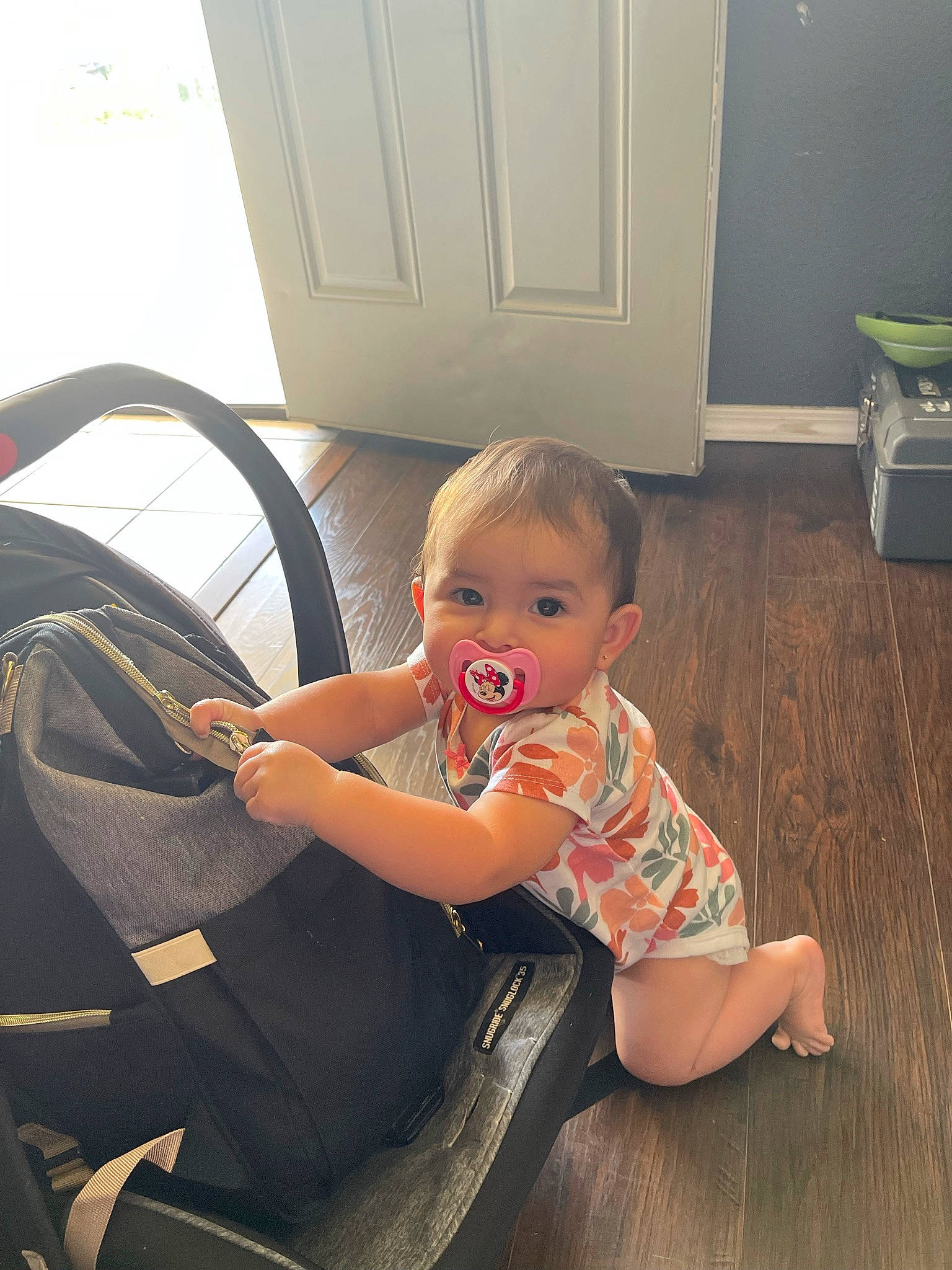 Elisabella is registered to the contest to win money with this photo: automotive_tire, baby, baby_toddler_clothing, comfort, flooring, hardwood, human_leg, joint, knee, lap, leg, motor_vehicle, person, skin, steering_wheel, thigh, tire, toddler, vehicle_door, wheel