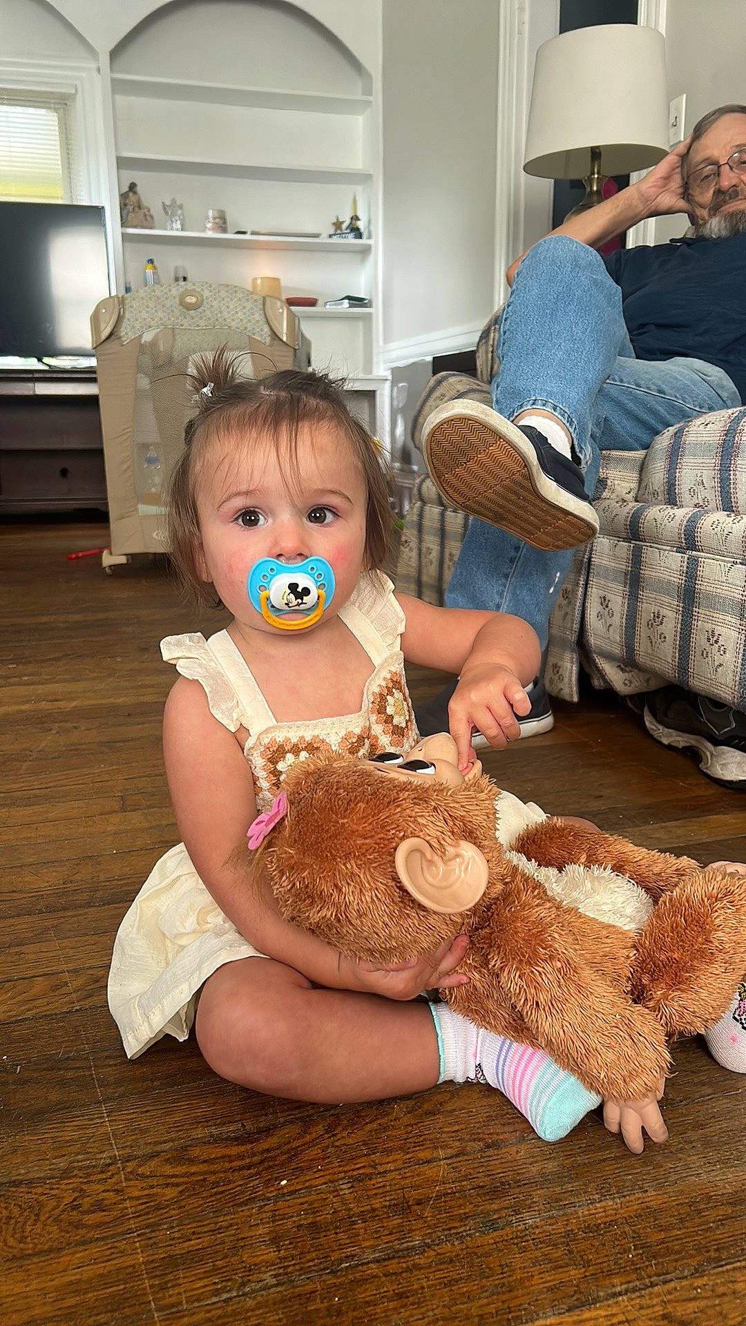 Piper is registered to the contest to win money with this photo: baby, cabinetry, child, comfort, couch, flooring, fun, happy, hat, home_appliance, human, mammal, people, person, sitting, skin, stuffed_toy, television, toddler, toy