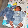Anthony Jr joined the competition — help win amazing prizes! baby, newborn, sleeping, plush_toy, blue_bunny, changing_mat, animal_prints, carpet, infant_clothing, winnie_the_pooh, toddler, cute, peaceful, indoors, soft_texture, child, person, legs, resting, comfort