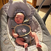 Anthony Jr is registered to the contest to win money with this photo: baby, infant, baby_rocker, seat, gray, white, soft_texture, cloud_pattern, indoor, carpet, wooden_door, newborn, cute, child, person, resting, small, comfortable, baby_clothing, seatbelt
