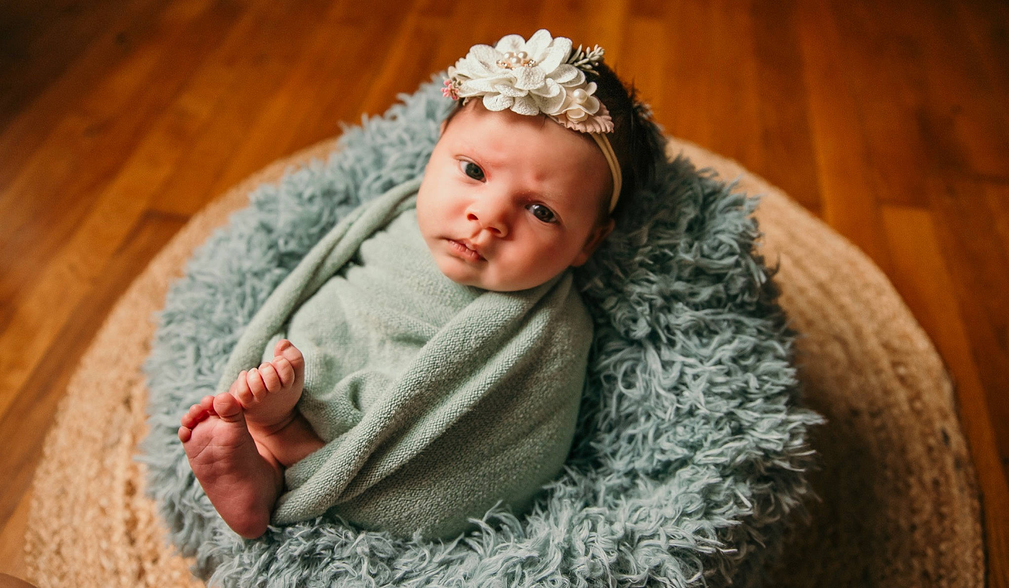 Kennedi is registered to the contest to win money with this photo: baby, baby_toddler_clothing, cap, close_up, comfort, eye, finger, grass, headband, headgear, headwear, knit_cap, linens, outerwear, pattern, person, skin, sleeve, toddler, wood