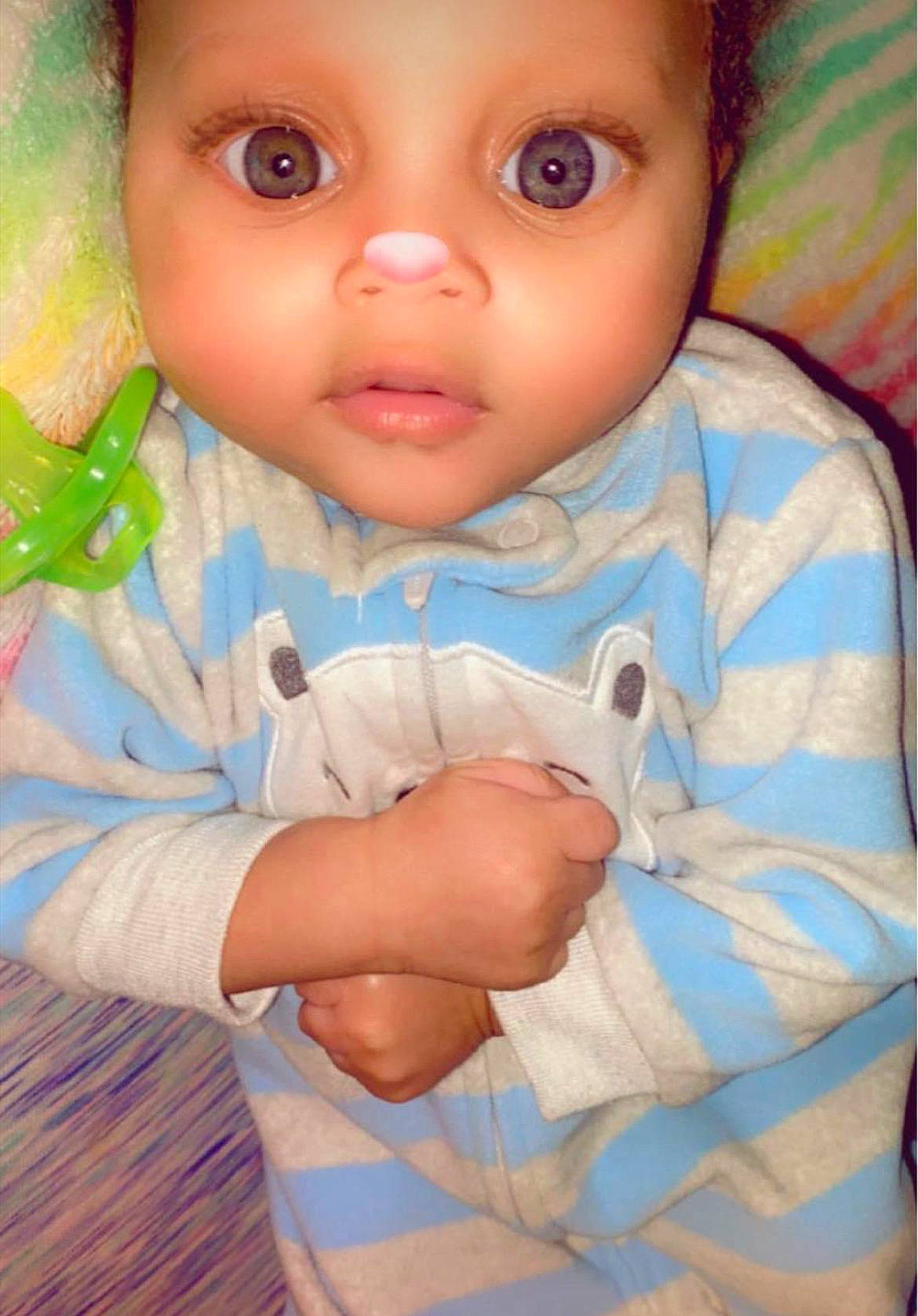 Karter is registered to the contest to win money with this photo: arm, baby, baby_toddler_clothing, cheek, chin, doll, eye, eyelash, finger, gesture, head, human_body, iris, lip, nose, person, pink, skin, sleeve, toy