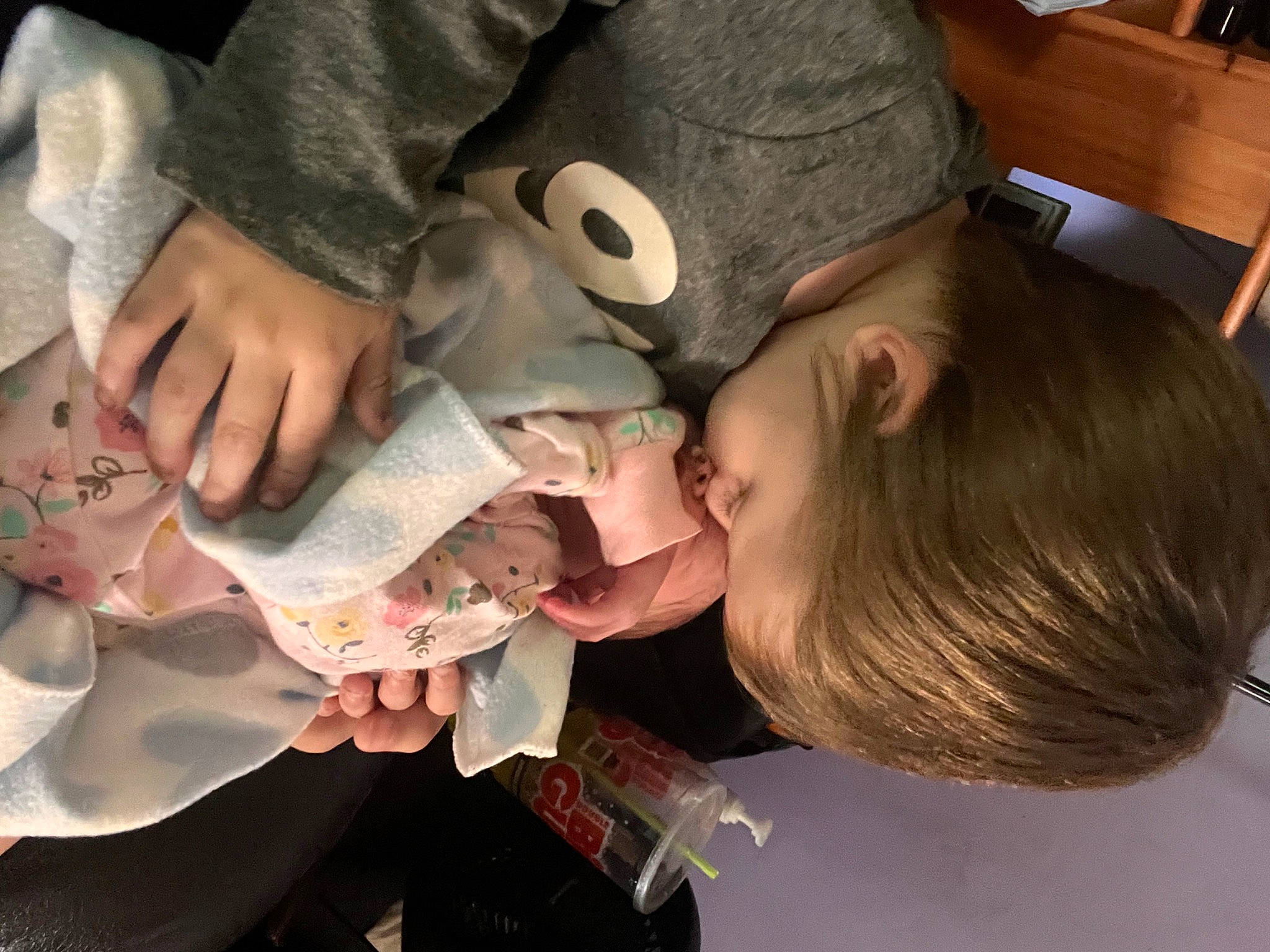 Dean is registered to the contest to win money with this photo: baby, child, drinkware, ear, eyelash, eyewear, fun, hair, hairstyle, happy, hat, head, helmet, mouth, nail, person, personal_protective_equipment, sitting, toddler, tree