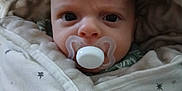 Dougie joined the competition — help win amazing prizes! baby, baby_clothing, blanket, child, closeup, cozy, cute, expression, face, head, indoor, infant, newborn, pacifier, portrait, sleepwear, soft, star_pattern, wide_eyes, wrapped