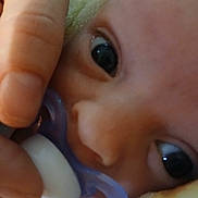 Dougie joined the competition — help win amazing prizes! baby, pacifier, hand, face, eye, infant, closeup, skin, fingers, child, newborn, soft, cute, person, mouth, expression, nurturing, comfort, rest, blanket