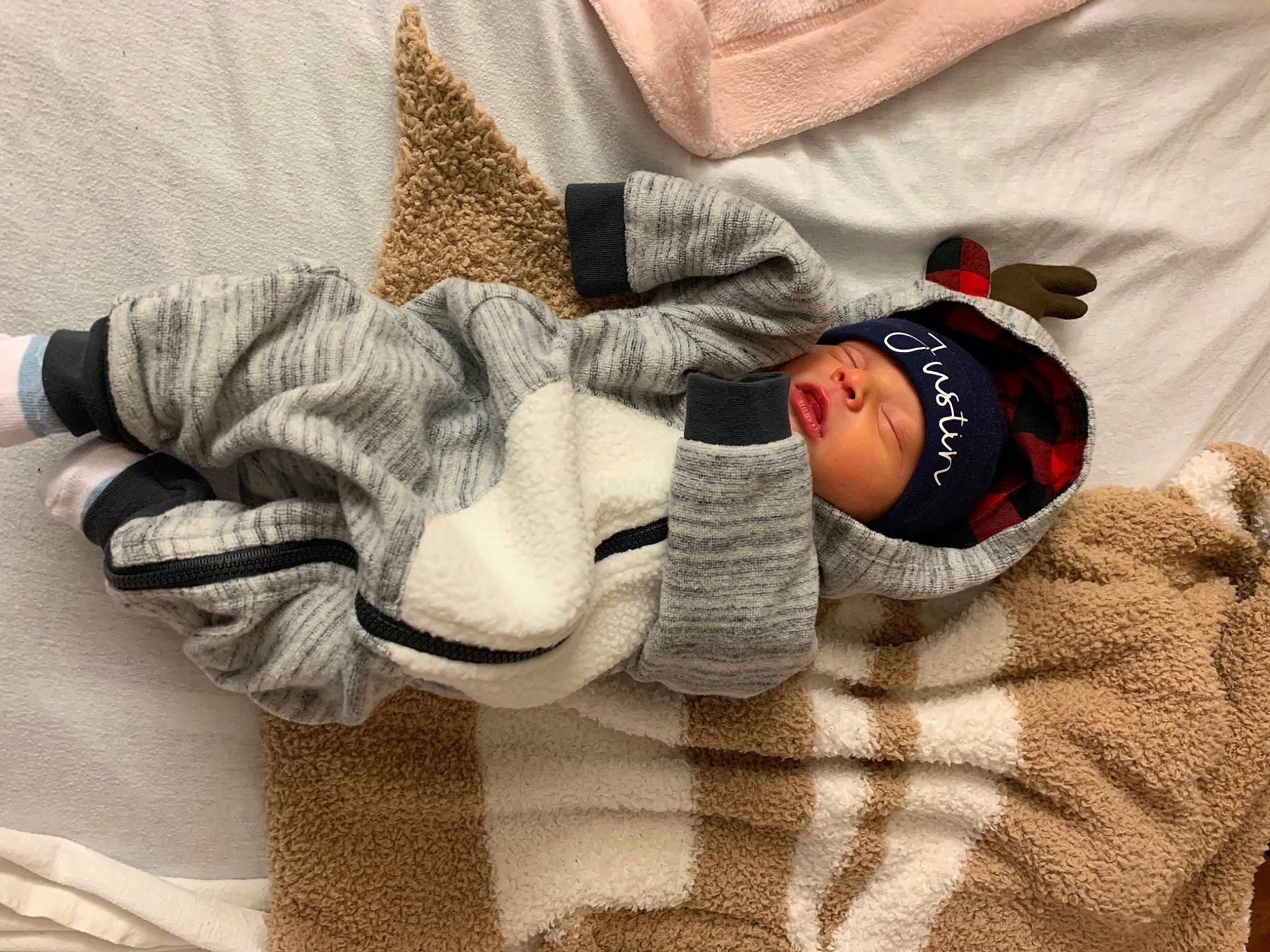 Justin joined the competition — help win amazing prizes! arm, baby, baby_sleeping, baby_toddler_clothing, cap, comfort, eye, finger, gesture, glasses, grey, hand, headwear, human_body, joint, leg, outerwear, person, sleeve, thumb