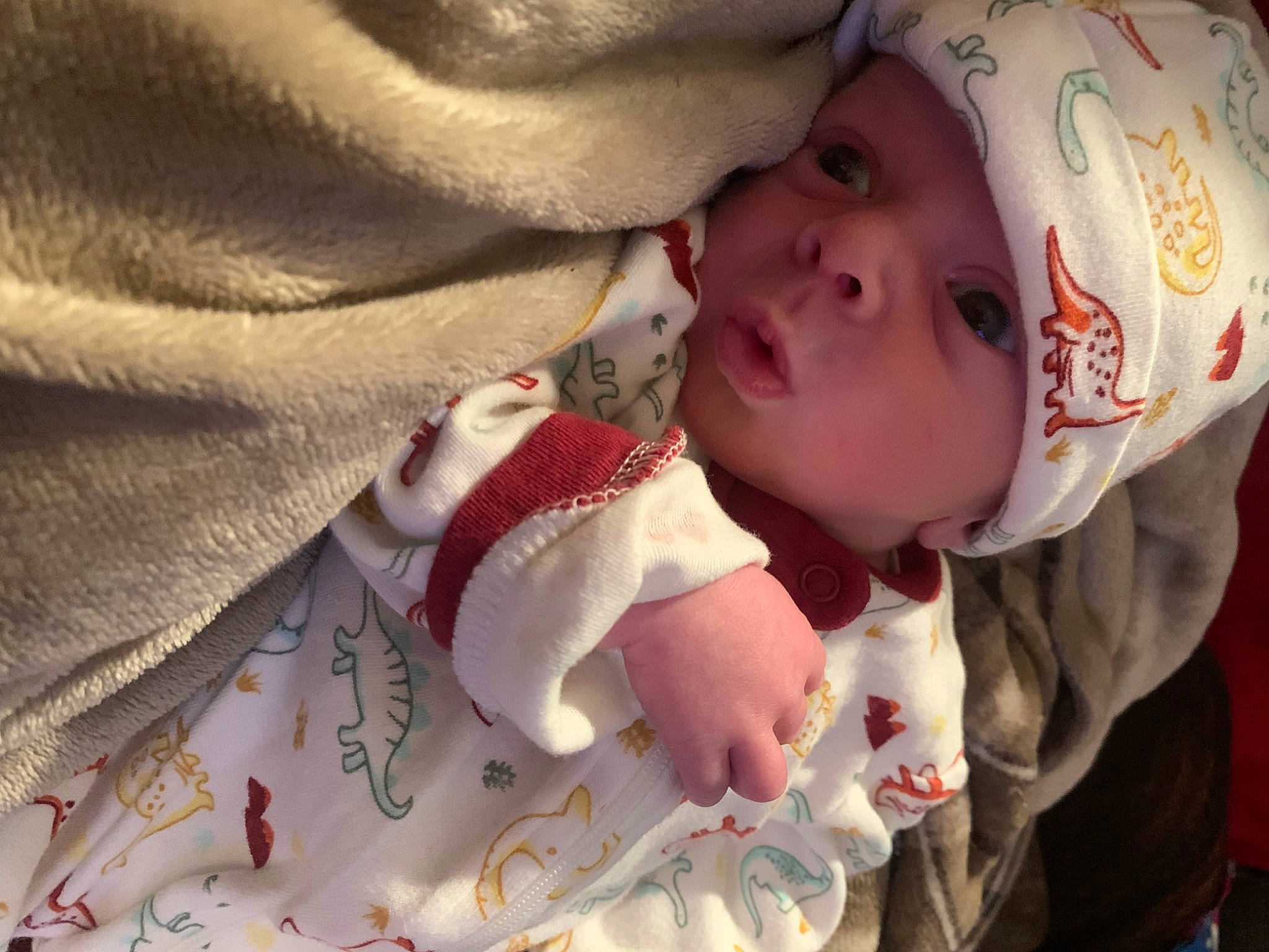 Justin is registered to the contest to win money with this photo: baby, baby_products, baby_toddler_clothing, carmine, cheek, child, comfort, eyelash, fur, happy, headwear, linens, lip, nose, pattern, person, skin, sleeve, textile, toddler