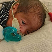 Josiah joined the competition — help win amazing prizes! newborn, baby, infant, face, pacifier, blanket, hospital, medical_device, nasal_cannula, sleeping, closeup, soft_texture, skin, head, human, resting, healthcare, cute, child, tenderness