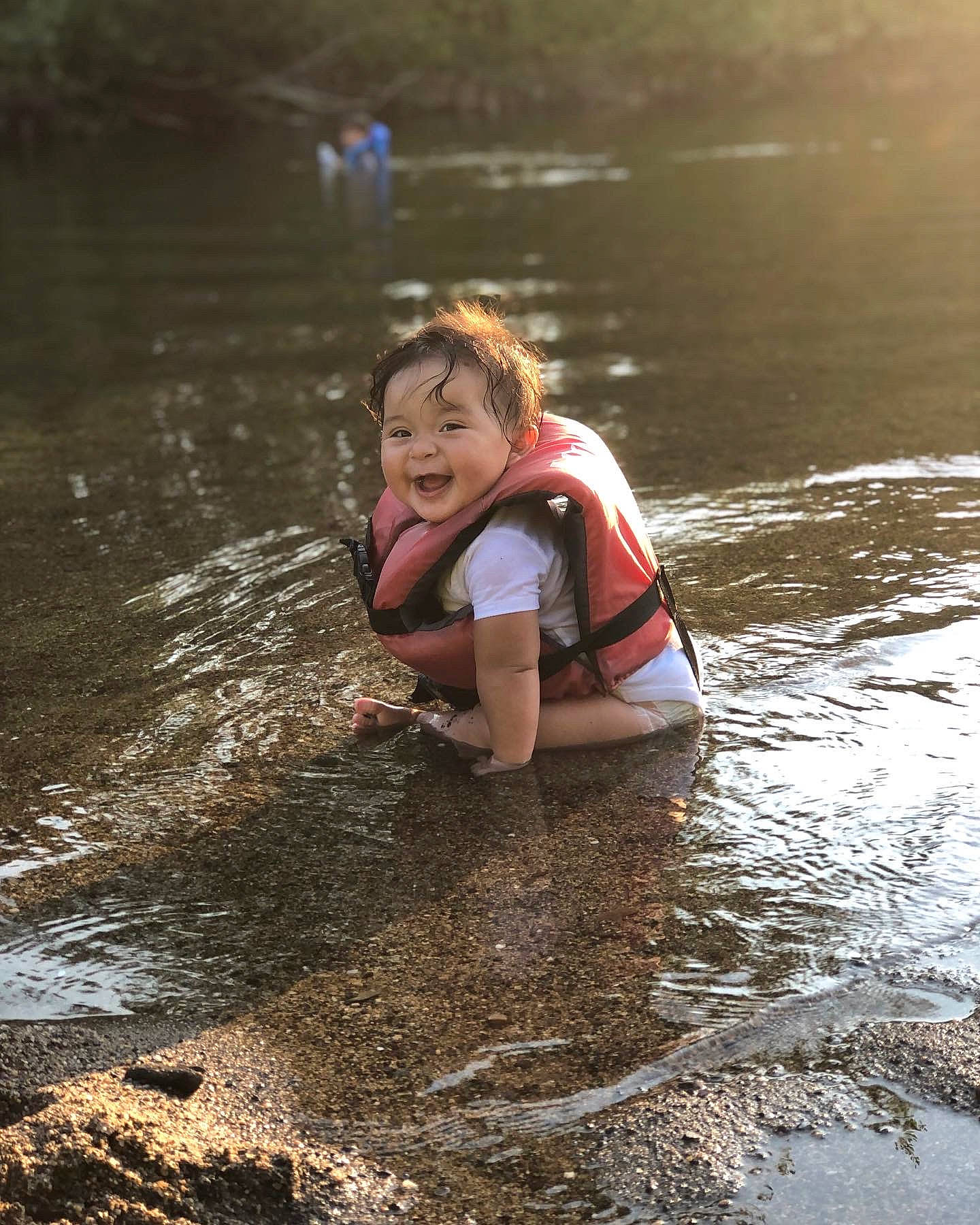 Danielle is registered to the contest to win money with this photo: bank, flash_photography, fun, happy, lake, leisure, people_in_nature, person, personal_protective_equipment, plant, recreation, reflection, smile, soil, stream, t_shirt, tree, water, water_resources, watercourse