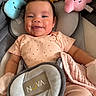 baby, infant, child, smiling, happy, portrait, car_seat, plush_toys, stuffed_animals, cloud_toy, sun_toy, pink_clothing, blanket, harness, seated, indoor, close_up, face, toy, photography