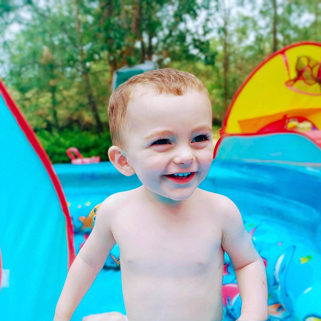 Kaiden is registered to the contest to win money with this photo: arm, azure, chest, child, electric_blue, fun, happy, human_body, joy, leisure, neck, people_in_nature, person, play, product, recreation, sitting, smile, summer, t_shirt