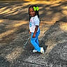Zabria joined the competition — help win amazing prizes! blue_pants, braided_hair, casual_clothing, child, daytime, girl, green_bow, happy, jump_rope, nature, outdoor, person, playful, recreation, shadow, sidewalk, smiling, sneakers, sunlight, white_shirt