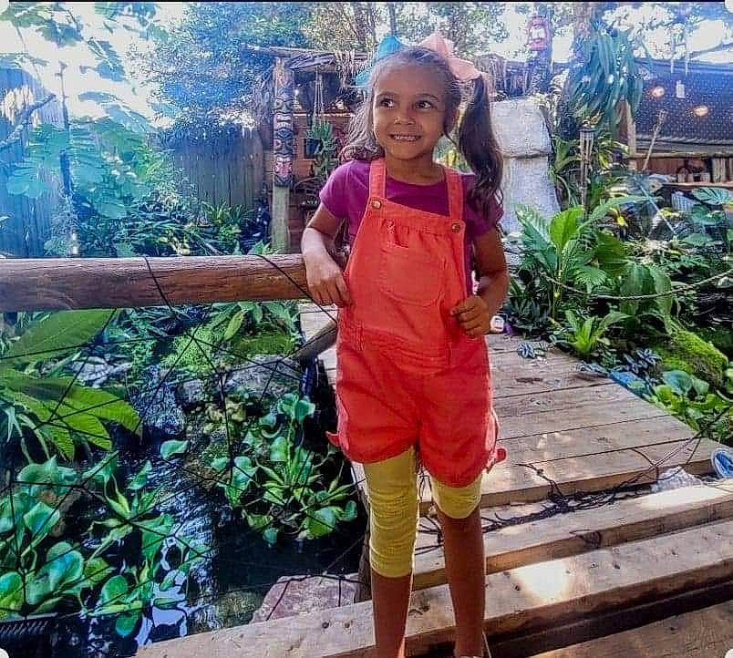 Daphne is registered to the contest to win money with this photo: botany, child, fun, garden, grass, happy, joy, jungle, landscape, leisure, person, plant, shorts, smile, t_shirt, thigh, toddler, tourism, travel, tree