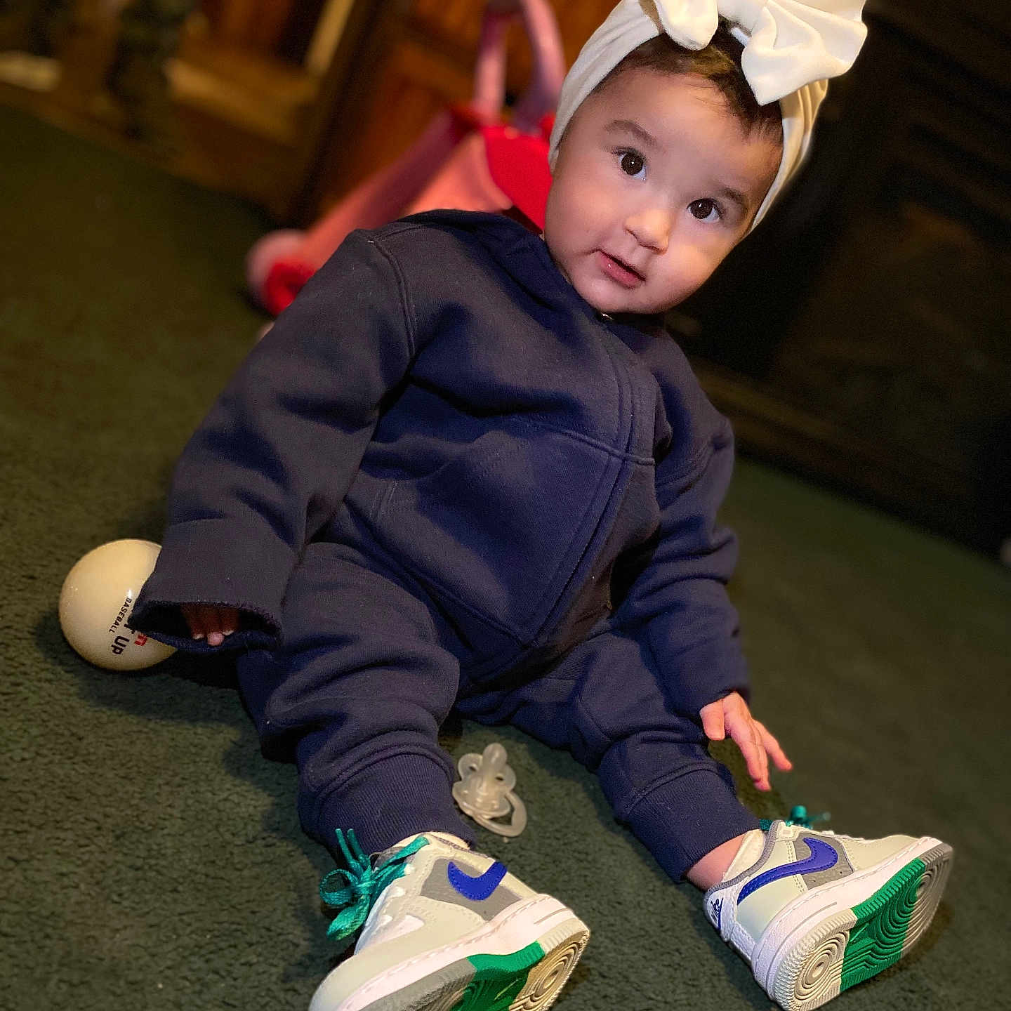 Vonah is registered to the contest to win money with this photo: bonnet, boy, child, clothing, coat, costume, face, footwear, hat, head, male, pants, person, photography, portrait, runningshoe, shoe, sitting, sneaker, wood