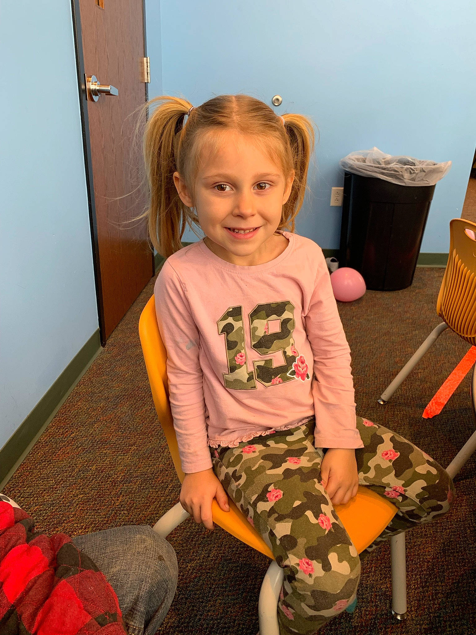 Lilah is registered to the contest to win money with this photo: baby_toddler_clothing, child, flooring, fun, happy, head, human_leg, joint, joy, pattern, person, play, room, shoe, shoulder, sitting, sleeve, smile, standing, thigh