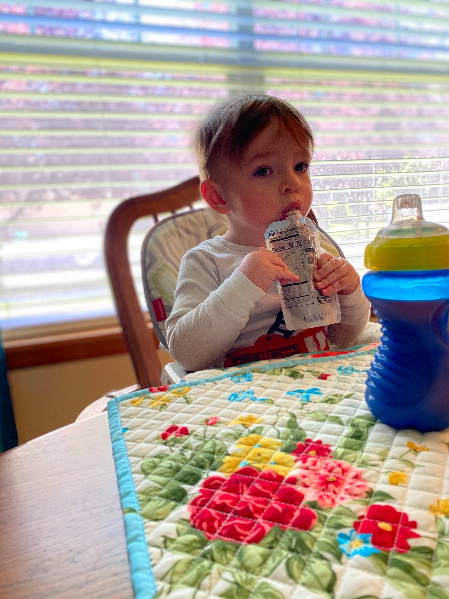 Kato is registered to the contest to win money with this photo: baby, bottle, chair, child, drinkware, event, fun, happy, leisure, linens, person, petal, plastic_bottle, play, recreation, table, toddler, toy_block, water, water_bottle