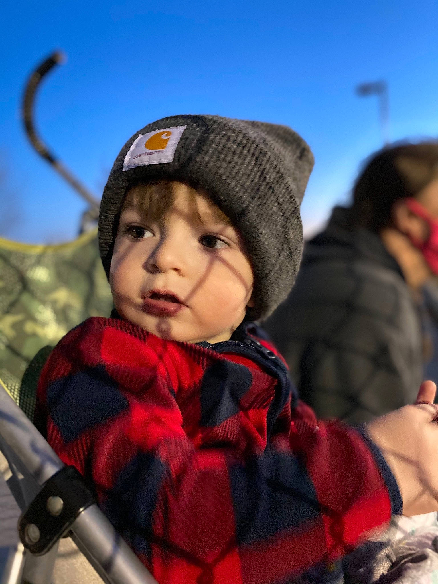 Kato is registered to the contest to win money with this photo: baby, baby_carriage, beanie, cap, child, fashion_accessory, freezing, fun, happy, headgear, headwear, knit_cap, landscape, leisure, person, personal_protective_equipment, recreation, sky, toddler, travel