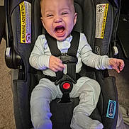 Malek is registered to the contest to win money with this photo: baby, car_seat, infant, happy, smiling, pajamas, straps, indoor, car_seat_warning, seat_belt, child, young, person, cozy, car_seat_padding, car_seat_harness, car_seat_cushion, car_seat_safety, child_safety, car_seat_infant