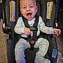 baby, car_seat, infant, happy, smiling, pajamas, straps, indoor, car_seat_warning, seat_belt, child, young, person, cozy, car_seat_padding, car_seat_harness, car_seat_cushion, car_seat_safety, child_safety, car_seat_infant