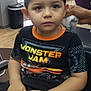 Isaiah joined the competition — help win amazing prizes! child, boy, haircut, barbershop, towel, shirt, monster_jam, hands, chair, indoor, person, hairstyle, face, hair, waiting, expressionless, floor, window, furniture, skin