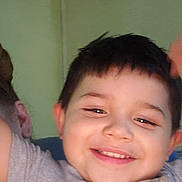 Isaiah joined the competition — help win amazing prizes! child, smiling, happy, boy, portrait, indoor, tshirt, raising_arms, face, hair, wall, framed_photos, collage, casual_clothing, expression, cheerful, person, cute, young, playful