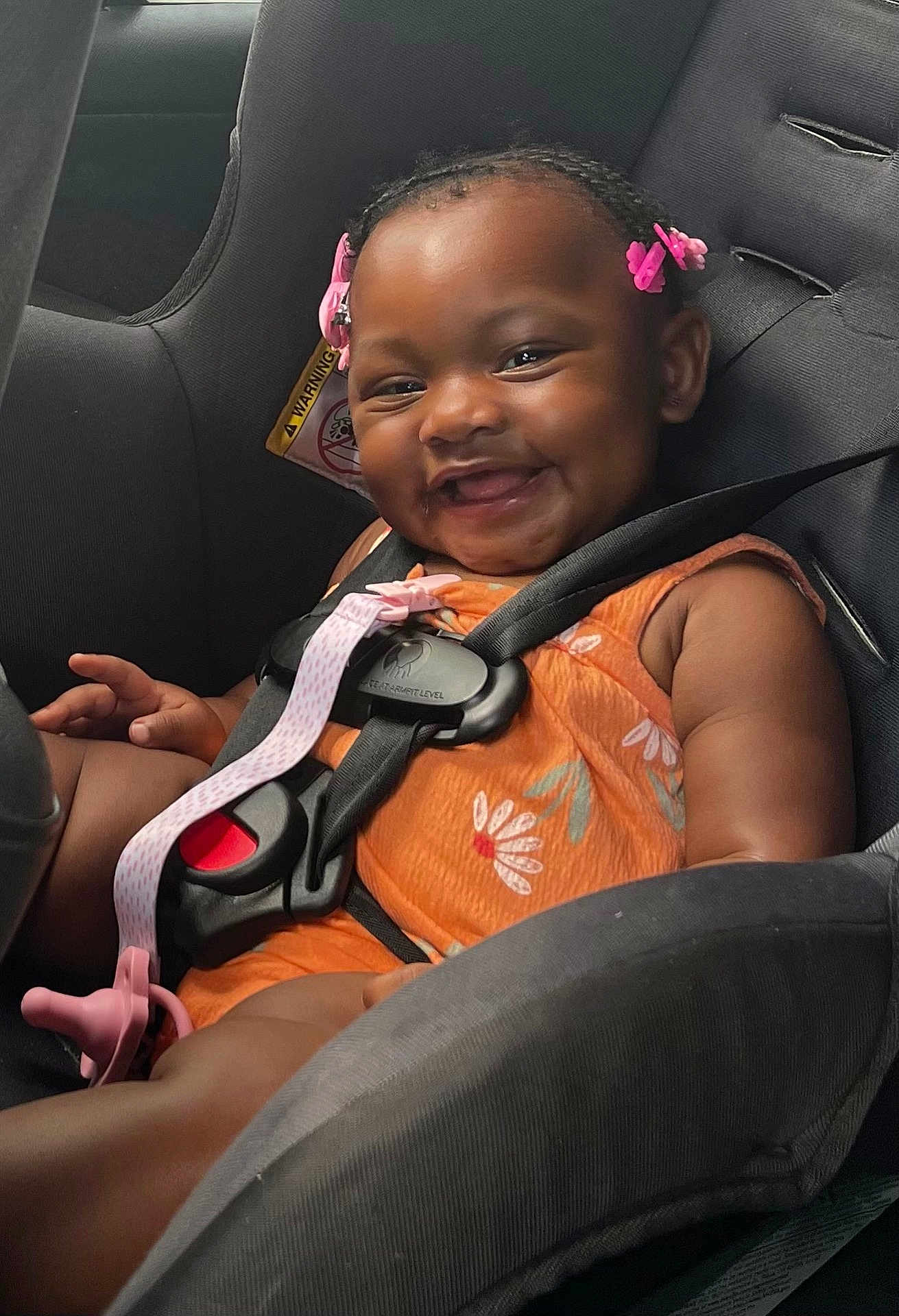 Zailynn joined the competition — help win amazing prizes! baby, child, car_seat, smiling, happy, hair_clips, orange_clothing, seatbelt, infant, cute, safety, car_interior, portrait, young_child, child_safety, baby_girl, seat, straps, fun, joyful