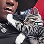 Nevaeh joined the competition — help win amazing prizes! person, cat, kitten, sleeping, closeup, portrait, black_clothing, headscarf, jewelry, necklace, heart_pendant, indoor, couch, red_cushion, affection, pet, tabby_cat, white_paws, collar, relaxation