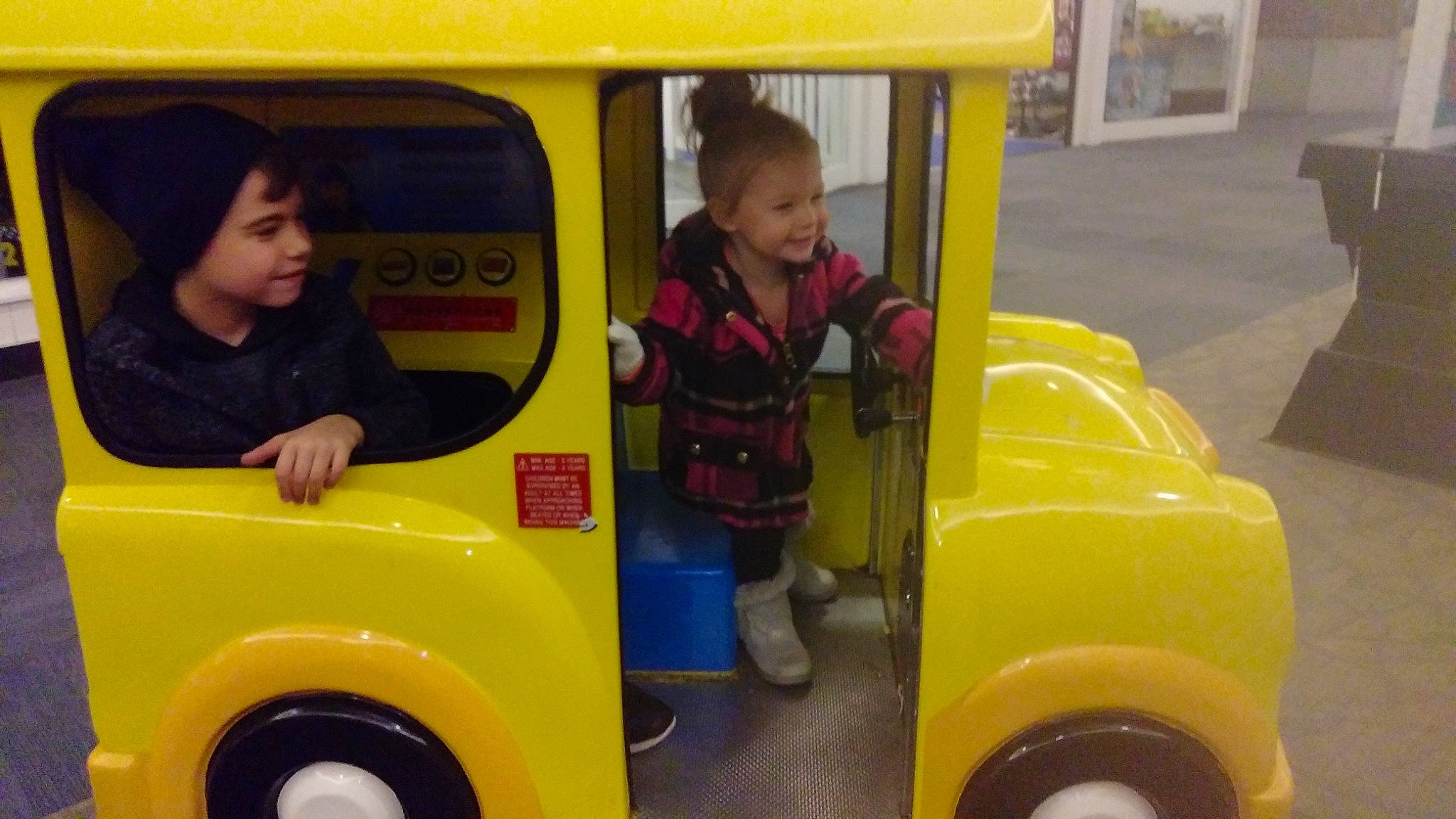 Elliette is registered to the contest to win money with this photo: car, child, joy, mode_of_transport, motor_vehicle, person, school_bus, toddler, vehicle, yellow