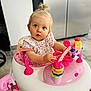 Lola participe au concours pour gagner de l'argent avec cette photo : blue_eyes, child, clothing, colorful, curious, floor, hair, indoors, kitchen, modern, person, pink, plastic, play, seat, toddler, toy, walker, white, young
