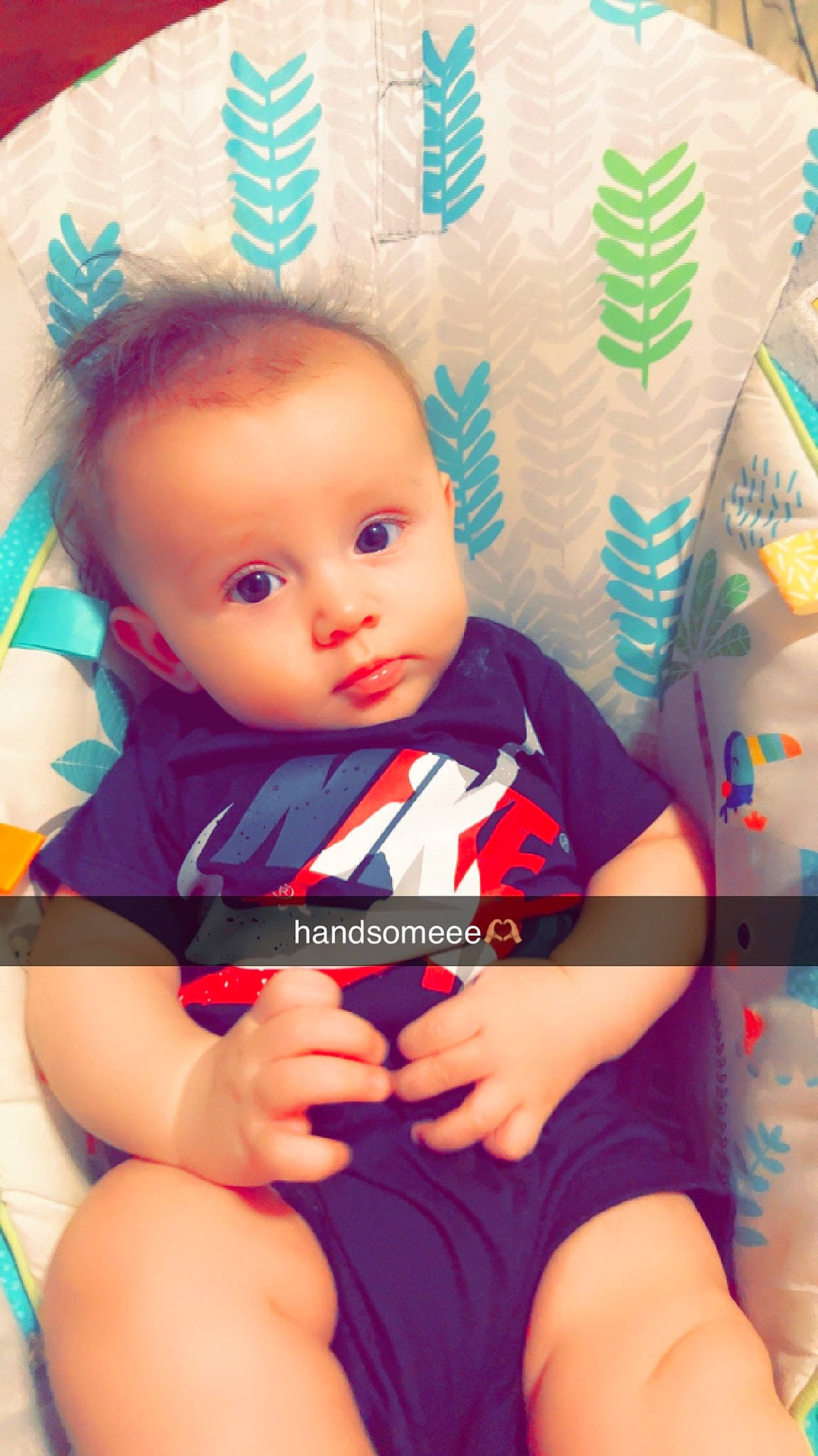 Matayo is registered to the contest to win money with this photo: baby, baby_toddler_clothing, cheek, chest, child, chin, comfort, elbow, electric_blue, eye, happy, human_leg, iris, knee, nose, pattern, person, sitting, skin, thigh