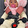 baby, infant, child, car_seat, harness, pacifier, winter_clothing, knitwear, hat, mittens, pink_blanket, fluffy_blanket, portrait, sitting, indoors, close_up, face, dark_eyes, cozy, safety